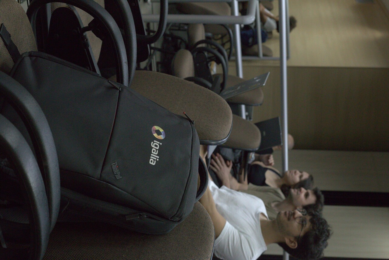 FOSForums 2026: Igalia backpack and audience